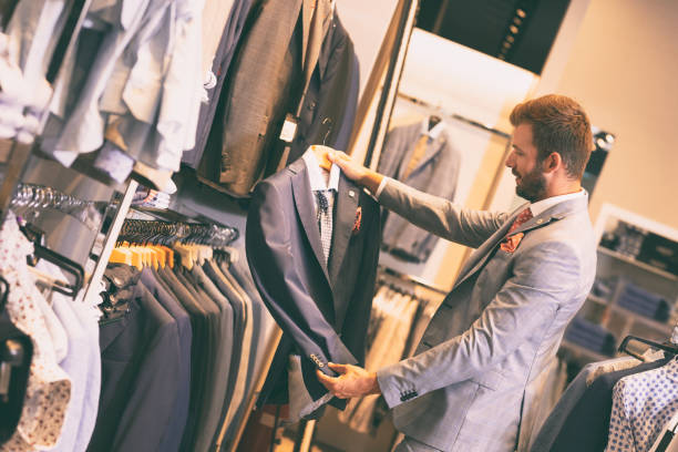 istock Handsome man choosing jacket in a shop 1180942219