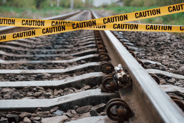 istock Be aware. Dangerous explosive lying on the railway. Yellow caution tape in front 1180942331