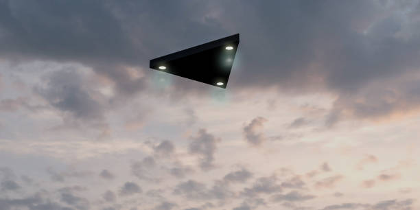 Triangular shaped ufo flying in the sky stock photo