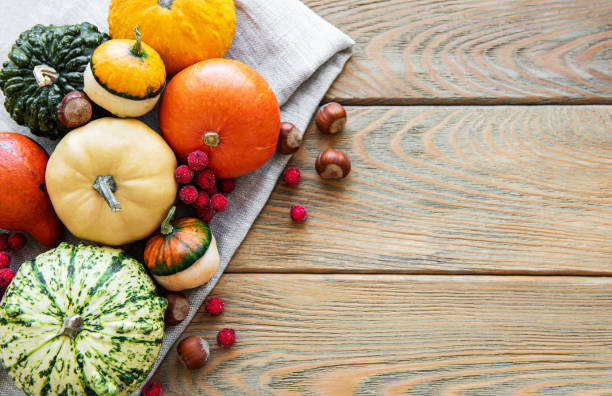 istock Pumpkins on a wooden table 1180943417
