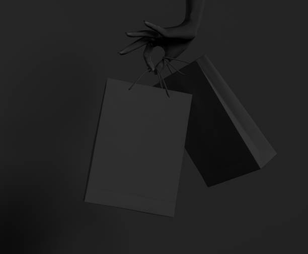 Close up black female hand holding black paper bag isolated on black background. Shopping and season sale concept template mock-up. Black Friday concept. Copy space. 3d illustration. Close up black female hand holding black paper bag isolated on black background. Shopping and season sale concept template mock-up. Black Friday concept. Copy space. 3d illustration. friday stock pictures, royalty-free photos & images