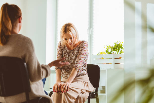 istock Psychotherapist explaining mature woman 1180945614