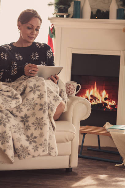 istock Mature woman using a tablet in the living room 1180948987