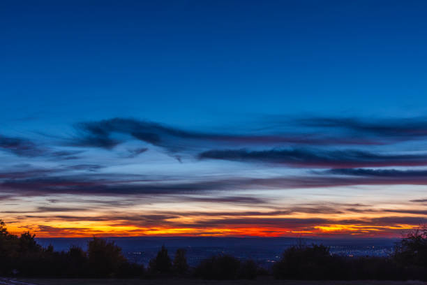 istock sunset over the city, dusk landscape with copy space, orange cloudscape 1180949500