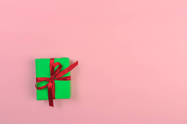 istock Gift box with ribbon and bow on color background and space for text. Top view 1180950050