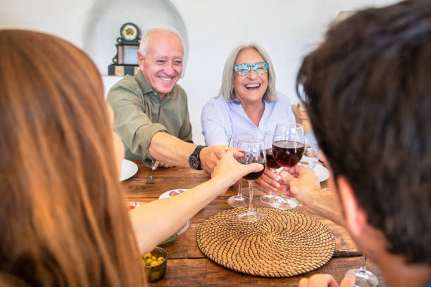 istock Carefree Spanish Seniors Toasting Before Midday Meal 1180950109
