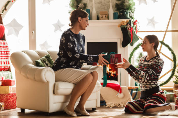 istock Parent and child exchanging Christmas gift 1180950499