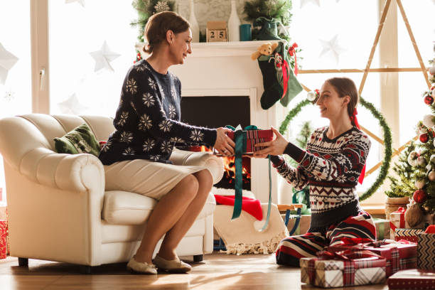 istock Mother giving daughter a Christmas gift 1180951103