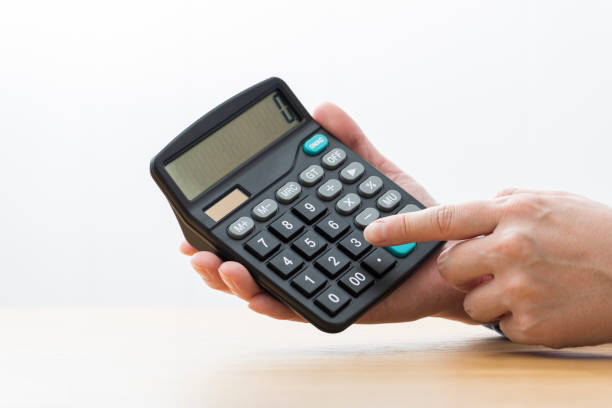 istock Man calculates used his holding calculator. 1180951576