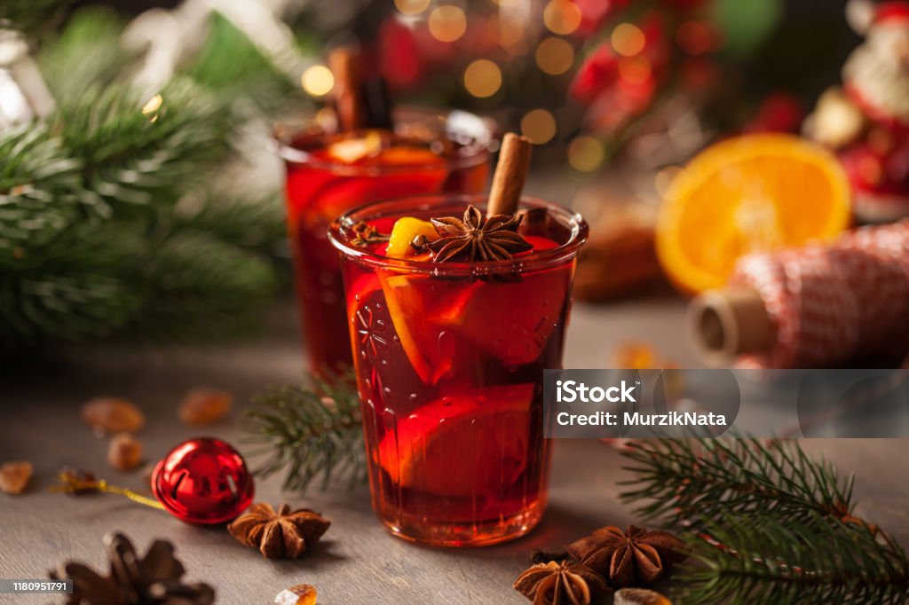 Christmas mulled wine with spices Christmas mulled wine with fruits and spices in glass on a wooden  background. Traditional hot drink at Christmas or Autumn time Christmas Stock Photo