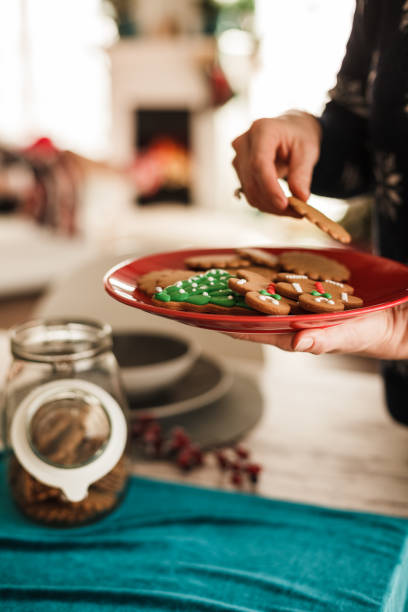 istock Woman's hand holding Christmas cookies 1180951882