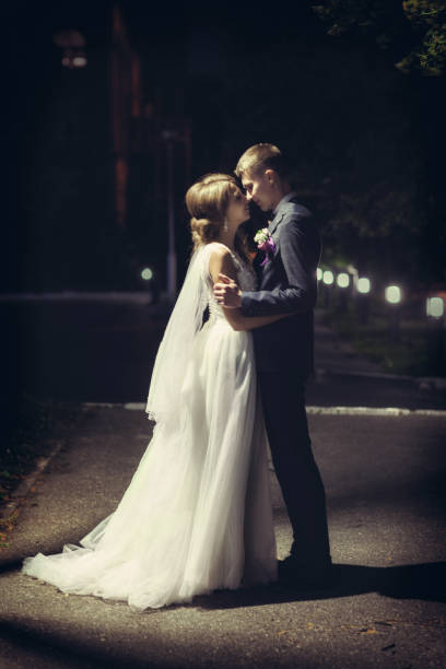 istock Newlyweds kiss under the lantern at night 1180953284