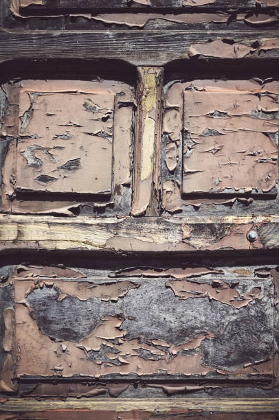 Old wooden door with peeling paint, color toning applied.