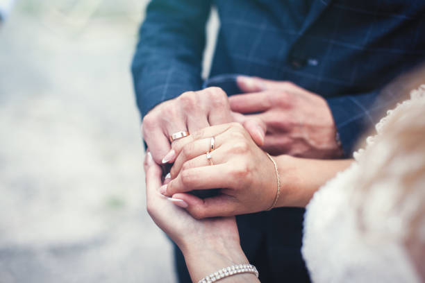 istock Wedding. Hands of the newlyweds with rings 1180954205