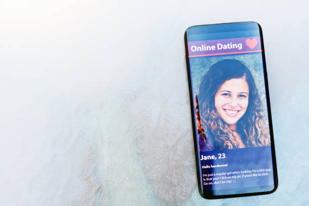 istock Smart phone displaying online dating site with pretty girl 1180954216