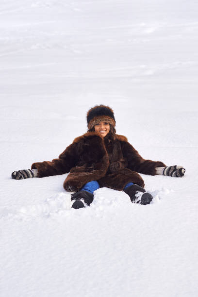 istock Young girl enjoying snow outdoors in winter. 1180954763