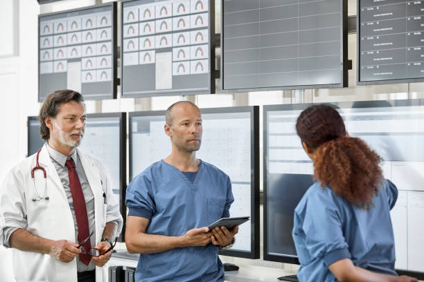 istock Doctors listening to nurse at control room 1180955538