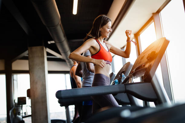 istock Young people running on a treadmill in modern gym 1180955772