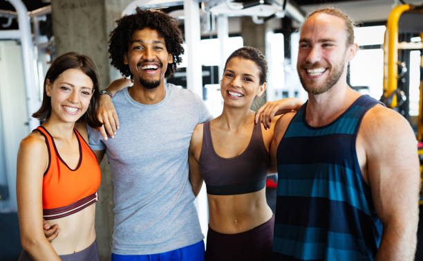 istock Group of young people doing exercises in gym 1180956382