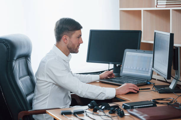istock Ready to work. Polygraph examiner works in the office with his lie detector's equipment 1180956730