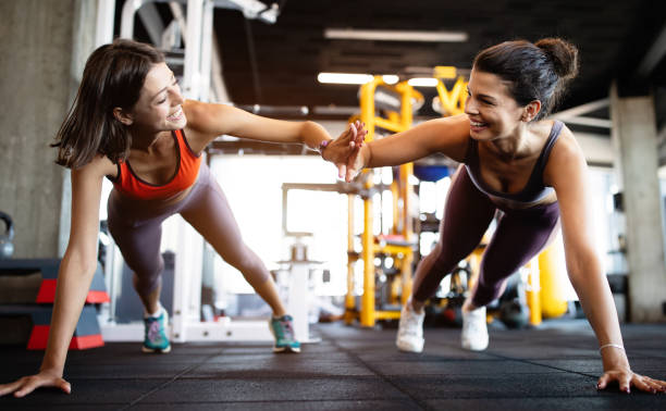 istock Beautiful fit people working out in gym together 1180956907