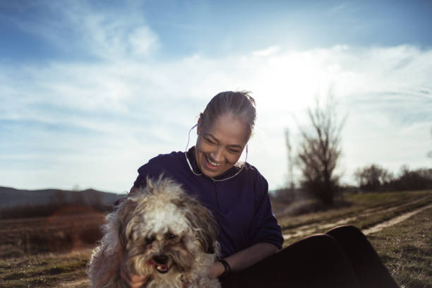 istock Senior woman playing with dog 1180957883