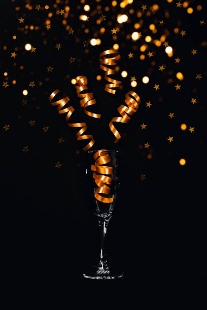 istock Christmas card. Glass with tinsel and lights. 1180958250