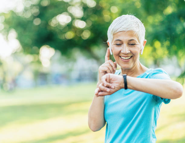 istock Athletic senior woman using smart watch 1180959131