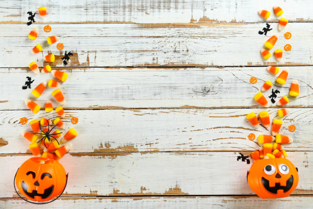 istock Bright colorful candy corn scattered on textured surface as symbol of autumnal holidays. 1180960705