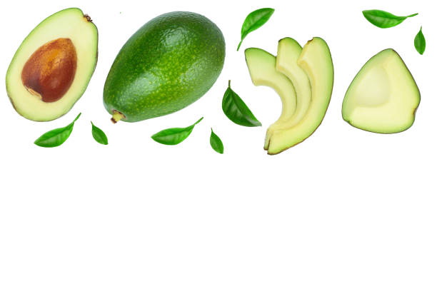 istock avocado and slices decorated with green leaves isolated on white background with copy space for your text. Top view. Flat lay 1180961058