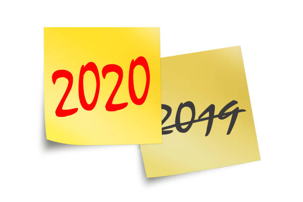 istock 2020 and 2019 written on yellow sticky notes isolated on white 1180961327