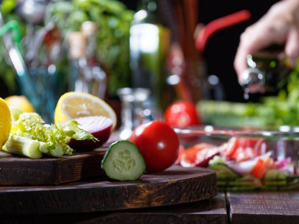istock Preparing tomato and cucumber salad 1180962225