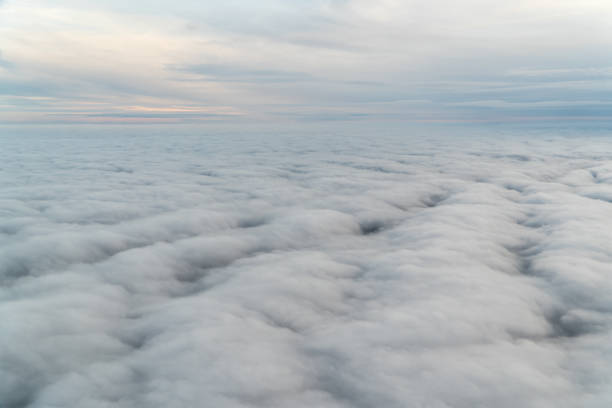 istock View from an airplane above the clouds 1180962459