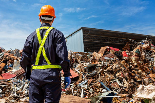 istock Engineer and recycle. An engineer looking at recycling waste To proceed to the next process. Male foreman wearing protective equipments and holding tablet and looking at Recyclable material. 1180962703