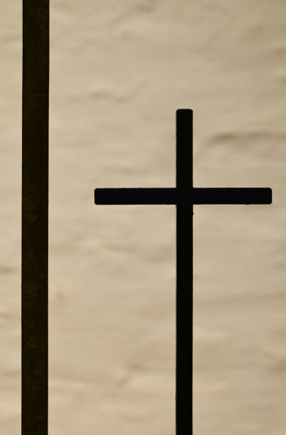 istock Silhouette of a crucifix in a Cornish Church 1180964252
