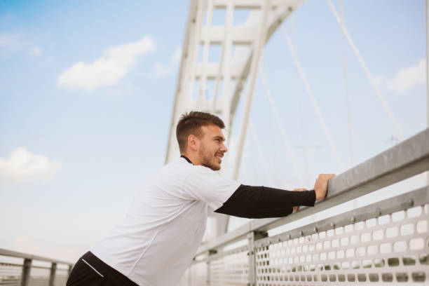 istock Photo of an athletic man stretching after exercise. 1180965589