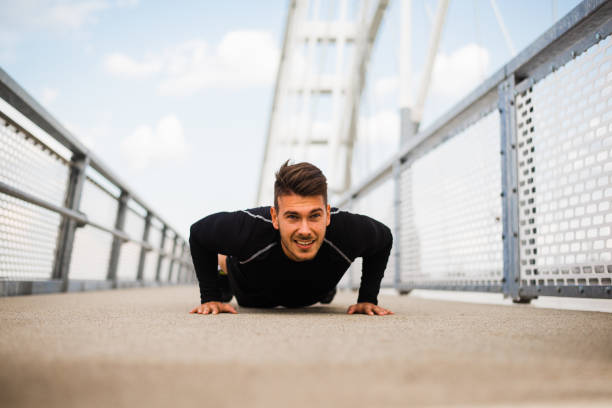 istock Photo of an athletic man stretching after exercise. 1180965944