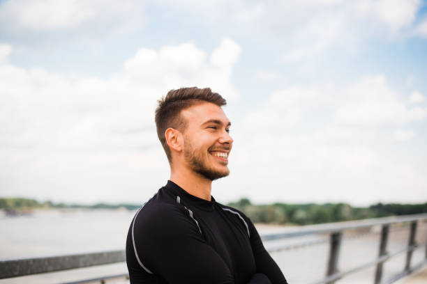 istock Photo of an athletic man stretching after exercise. 1180966008