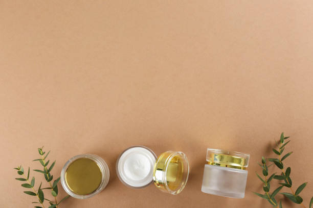 istock A can of white cream with eucalyptus leaves on paper textured background. 1180966046