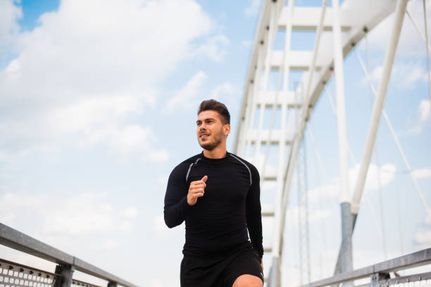 istock Photo of an athletic man stretching after exercise. 1180966778
