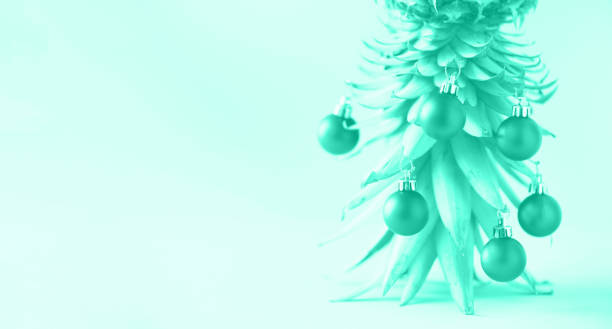 istock Creative Christmas tree made of pineapple and baubles on mint color background, copy space. Greeting card, decoration for new year party. Trendy green and turquoise color. Banner 1180967964