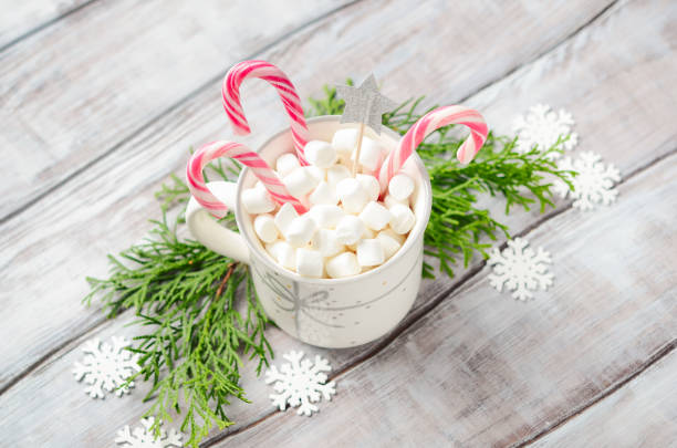 istock New Year or Christmas concept. Composition with marshmallows and candy canes on a wooden background. 1180968083