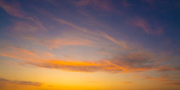 istock Sunset sky in orange and blue with clouds 1180970693