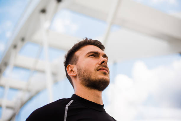 istock Photo of an athletic man stretching after exercise. 1180971677