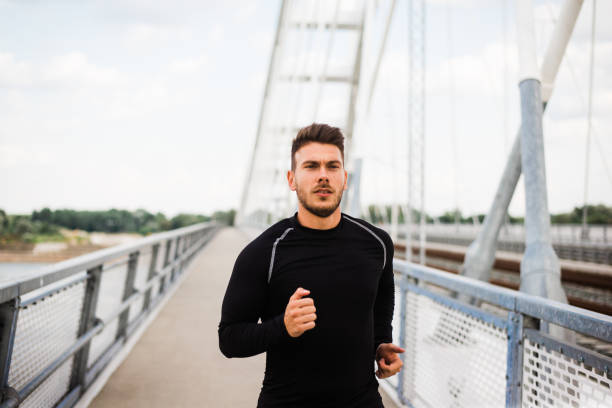 istock Photo of an athletic man stretching after exercise. 1180971817