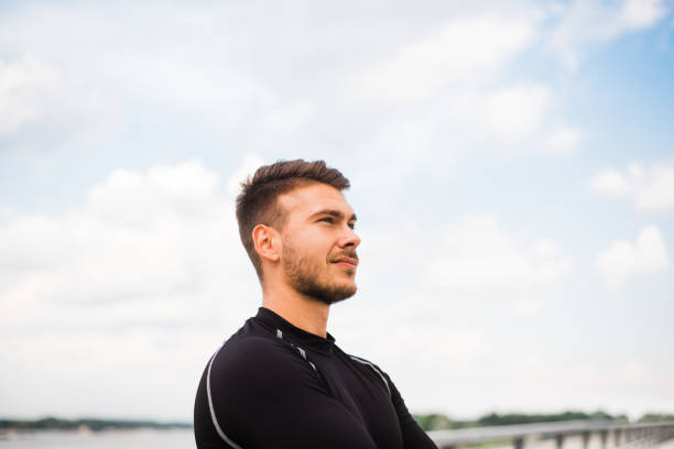 istock Photo of an athletic man stretching after exercise. 1180972095