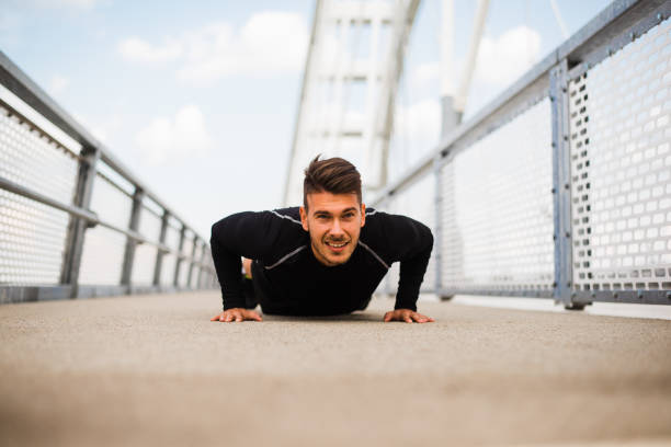 istock Photo of an athletic man stretching after exercise. 1180972152