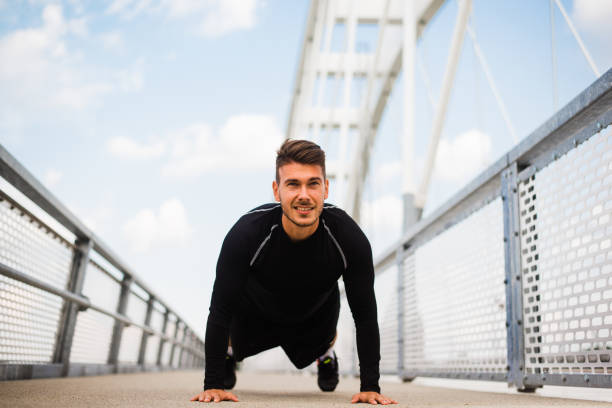 istock Photo of an athletic man stretching after exercise. 1180972181