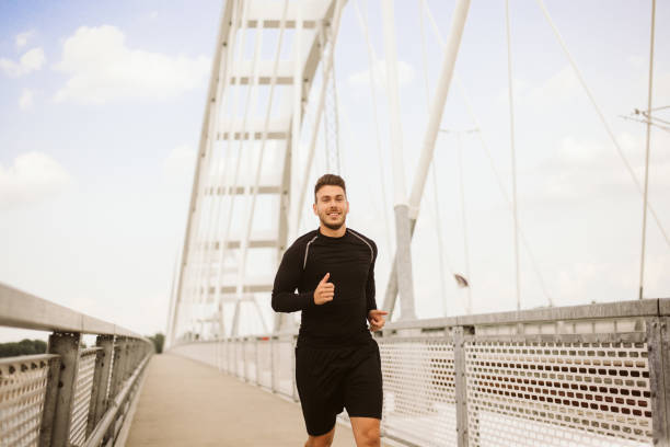 istock Photo of an athletic man stretching after exercise. 1180972246