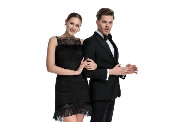 istock Elegant couple posing while she is holding his arm, 1180973073
